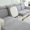 A light gray Jacquard elastic sofa cushion slipcover with a white accent cushion shown in a bright room.