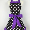 Purple and black polka dot ruffle apron with ties displayed on a mannequin.