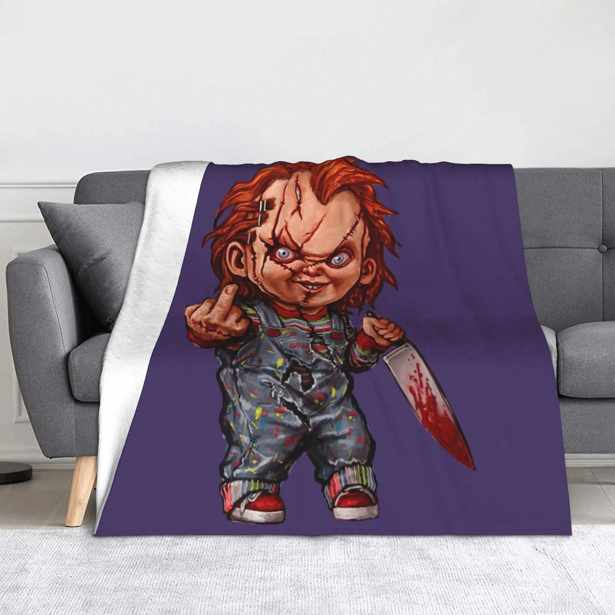 A purple graphic featuring Chucky from the horror movie, displayed on a gray sofa.