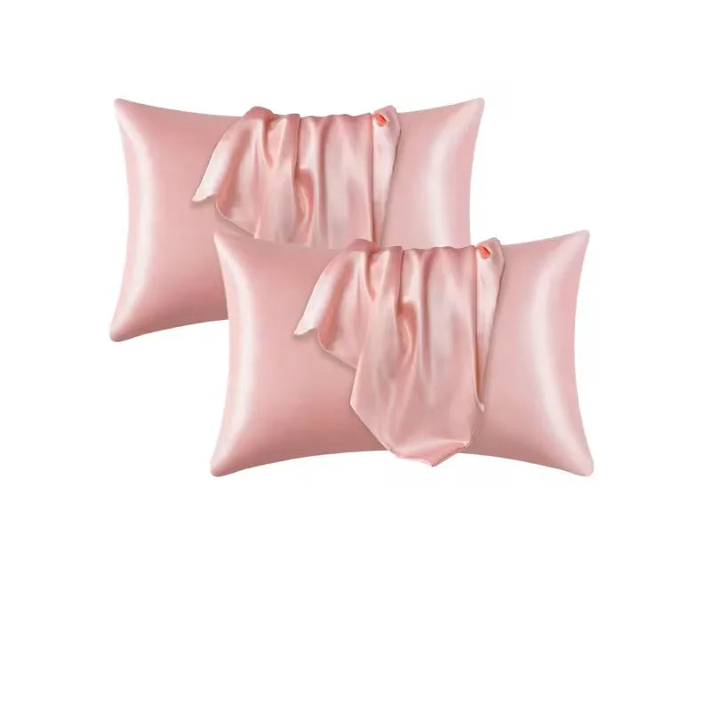 Three pink satin pillowcases with gathered fabric texture.