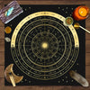 A dark fabric cloth featuring an astrological chart with zodiac signs and planetary positions, surrounded by tarot elements.