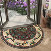 A semi-circular mosaic floor mat with a vintage floral print featuring greens, purples, and yellows on a light wood floor.