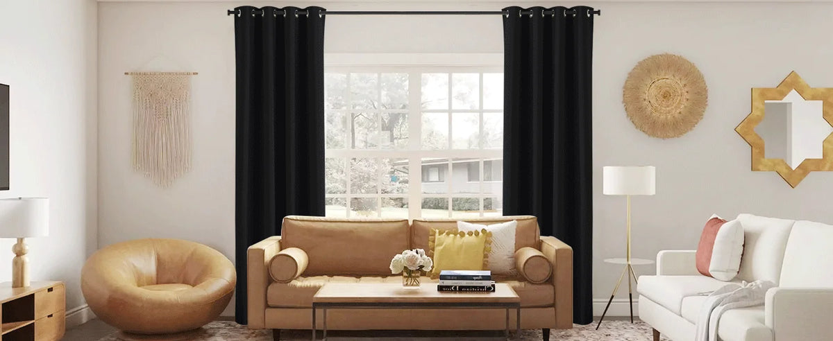 A living room features a beige sofa, wooden table, and large window covered by black blackout thermal drapes.