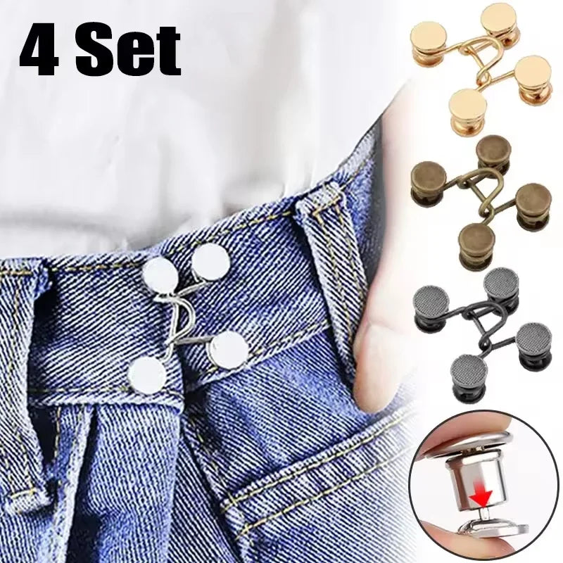 A set of four metal button snaps used for clothing and DIY projects shown on a denim fabric.