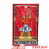 An embroidery patch depicting The Hanged Man with a rose skull motif in red and gold thread.