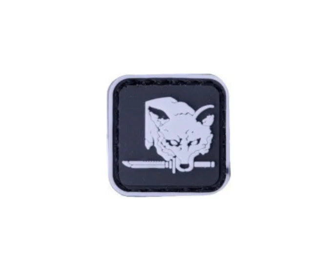 A black square patch featuring a white silhouette of a foxhound head and a knife.
