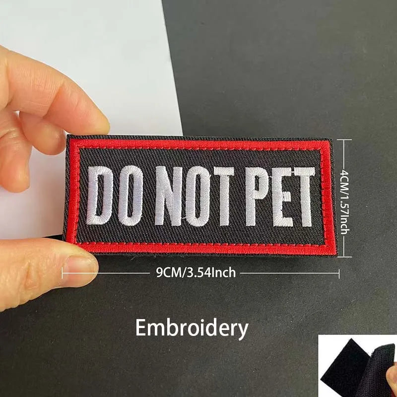 A black and red embroidered patch with the text DO NOT PET stitched onto a white background.