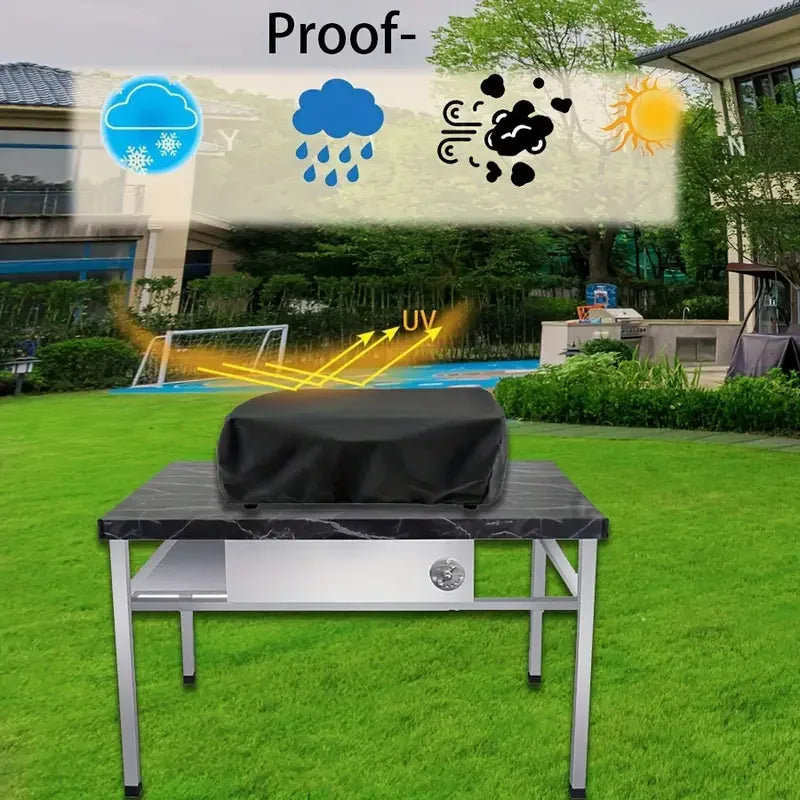 A black heavy-duty grill cover with a drawstring is placed on a silver table outdoors under sunlight and rain icons.