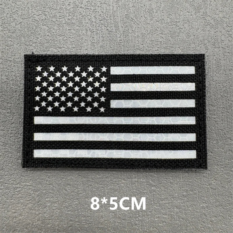 A black and white flag design featuring the American flag pattern with stars and stripes.