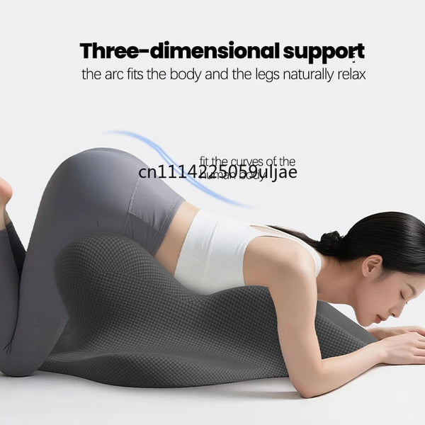 A woman is lying down, using a three-dimensional support garment for back and leg relaxation.