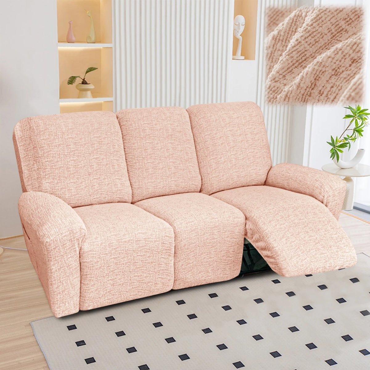 A light pink heavy-duty chenille recliner sofa slipcover placed on a gray patterned rug.