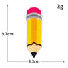 A yellow pencil shaped iron-on decorative patch with a pink tip and black tip, measuring 9.7cm long and 3.3cm wide.