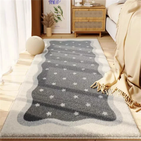 A gray and white patterned rug placed on a wooden floor next to a sofa and a cabinet.