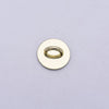 A round, gold-colored metal connector or charm with a central ring.