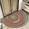 A circular boho half-round area rug with intricate geometric patterns in earthy and vibrant colors.