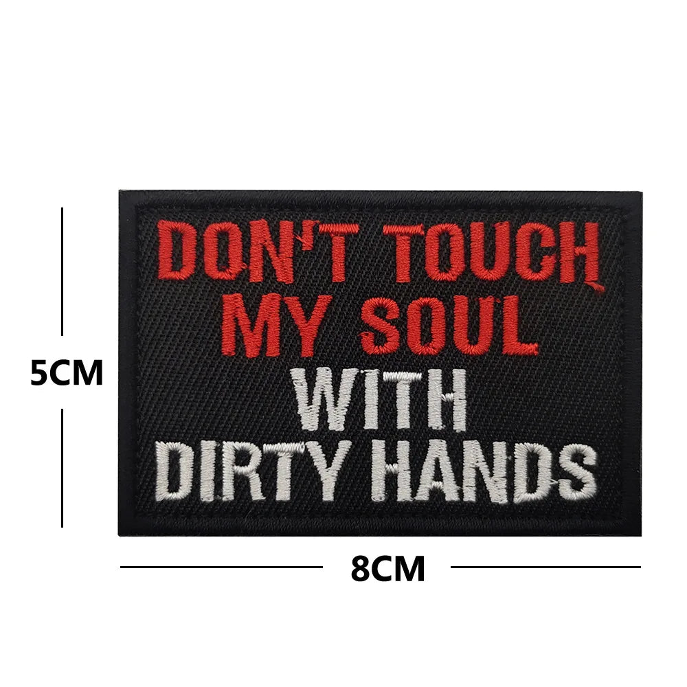 Black embroidered patch with red text that reads Don't touch my soul with dirty hands