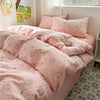 A pink floral microfiber duvet set with matching pillows and a light-colored room setting.