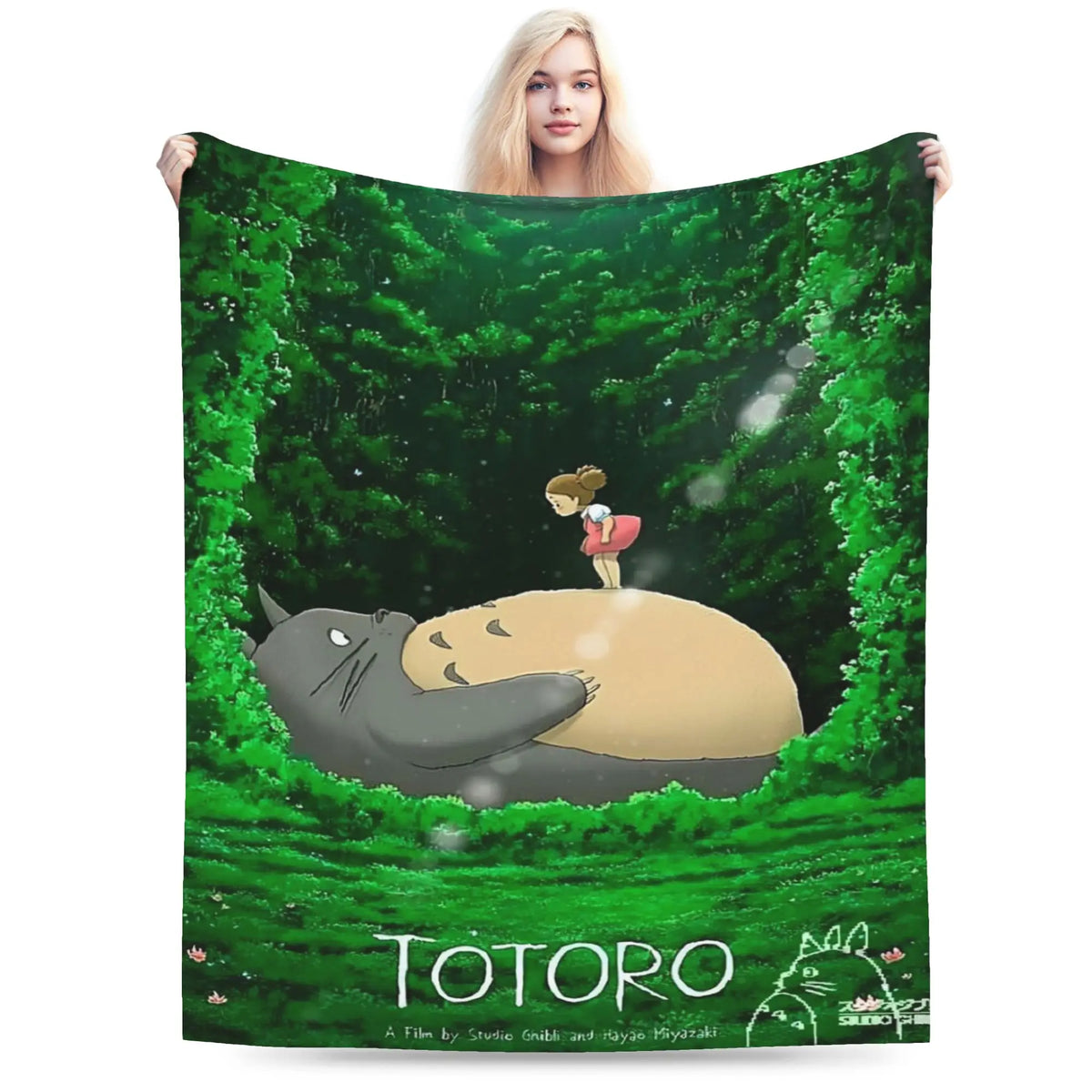 A green forest scene featuring the Totoro character on a fleece throw blanket.