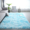 A bright blue fluffy rug placed in a modern living room with a window and a potted plant.