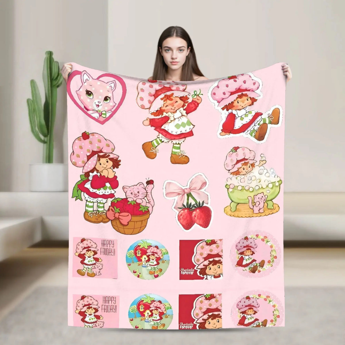 A pink strawberry shortcake themed plush throw blanket featuring characters and fruit designs.