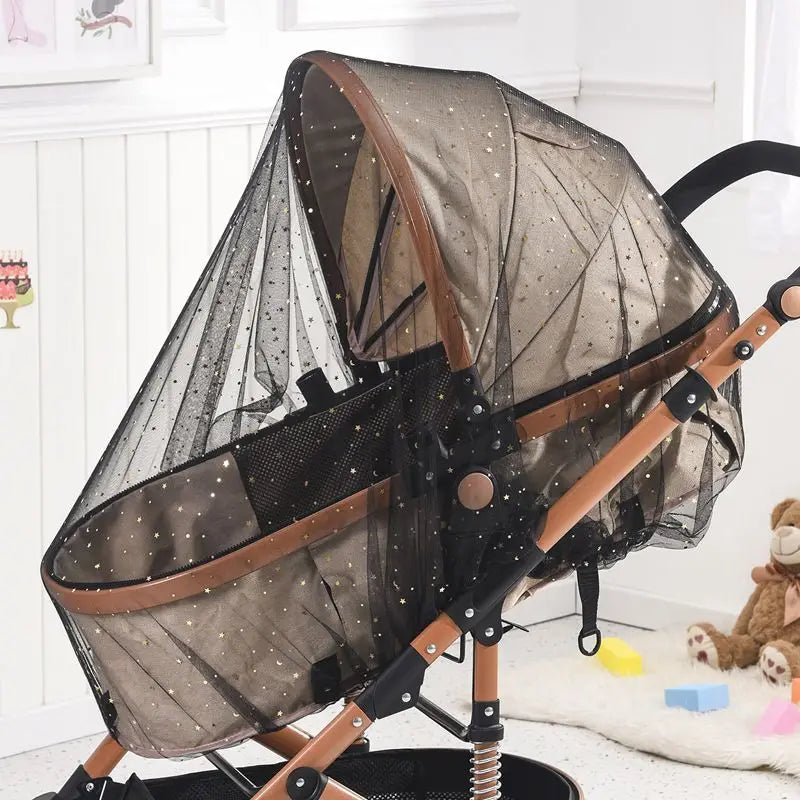 A foldable mosquito net canopy for an infant cot with a brown frame and sheer netting.