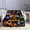 A printed flannel travel blanket featuring dark, vibrant artwork and textures.