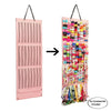 A pink storage hanger displaying a colorful assortment of hair clips and accessories.