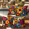 A collection of colorful floral patterned decorative pillow covers displayed on a light-colored sofa.