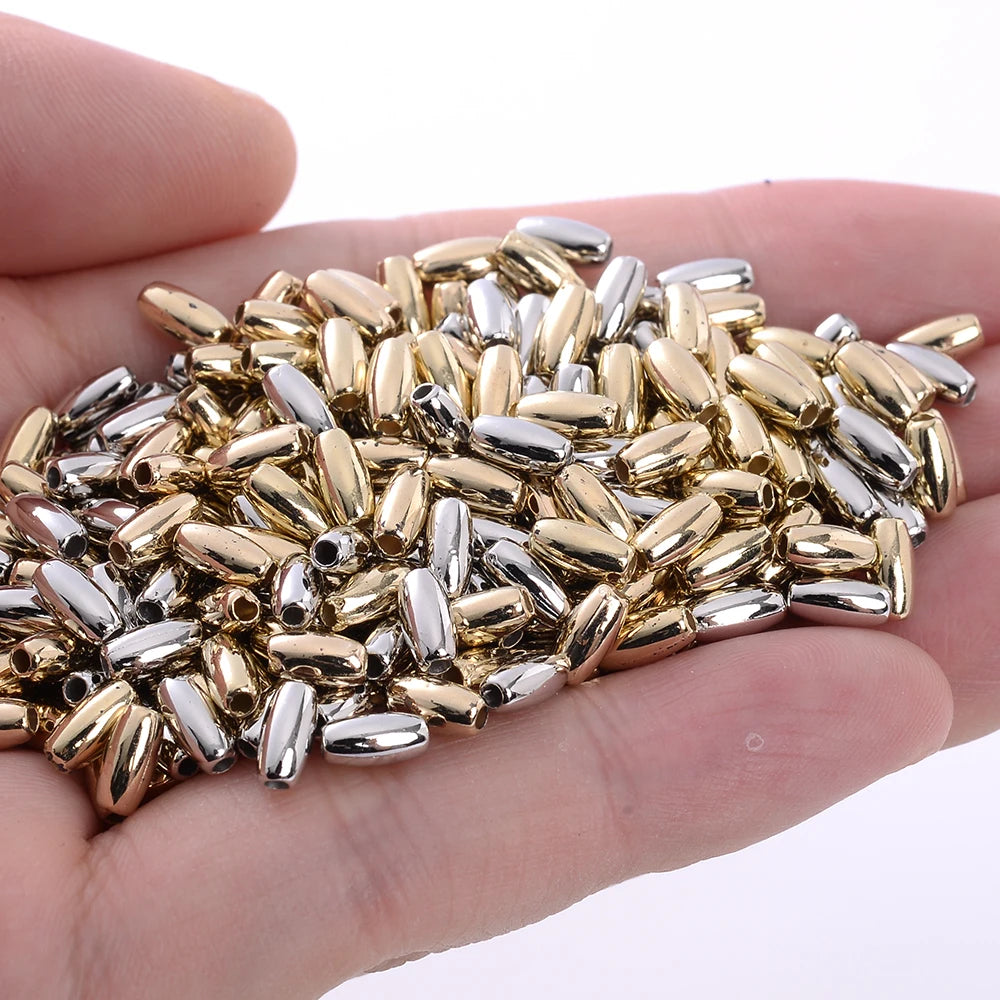A handful of mixed gold and silver geometric acrylic beads for jewelry making