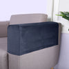 Dark navy velvet armrest covers placed on a light beige sofa.
