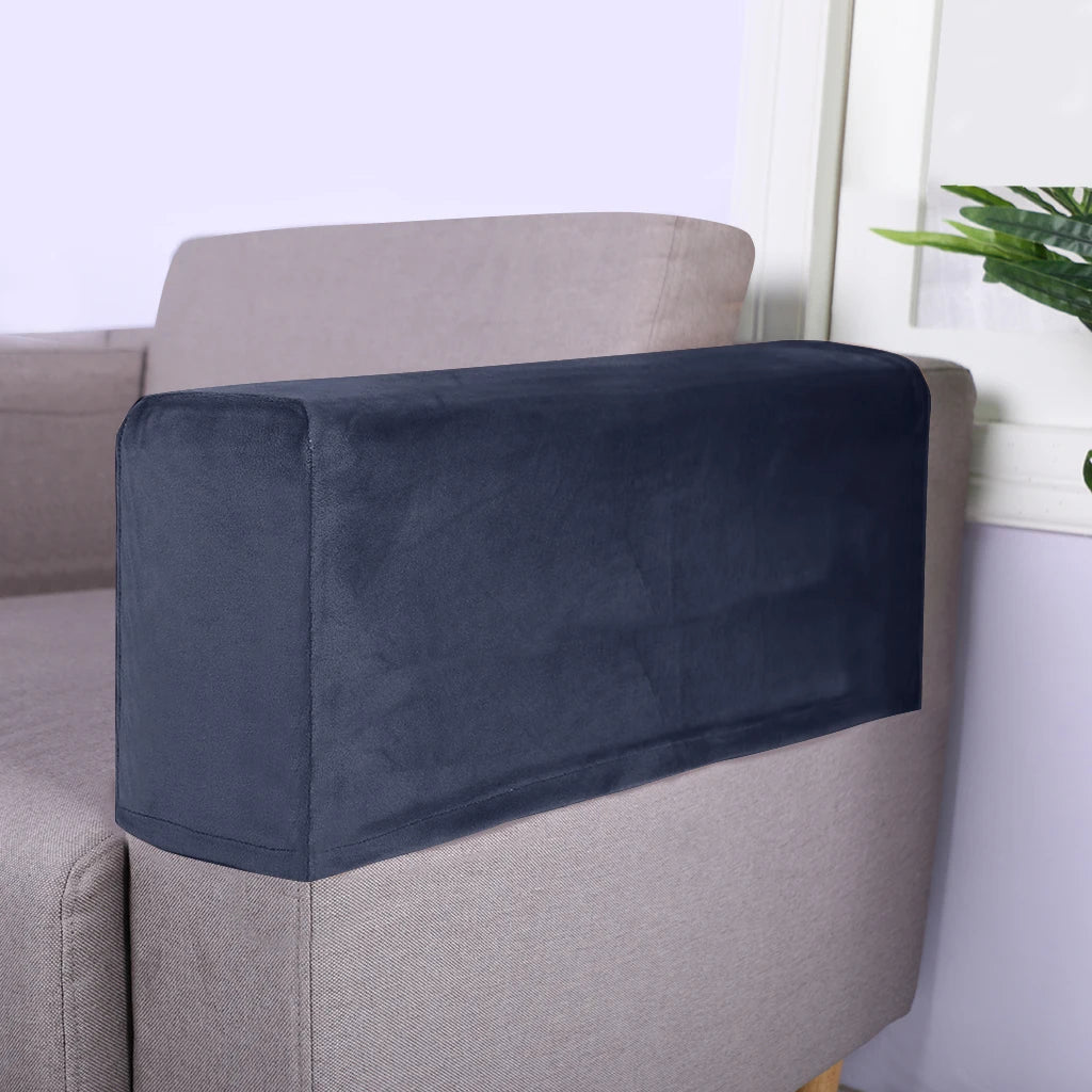 Dark navy velvet armrest covers placed on a light beige sofa.