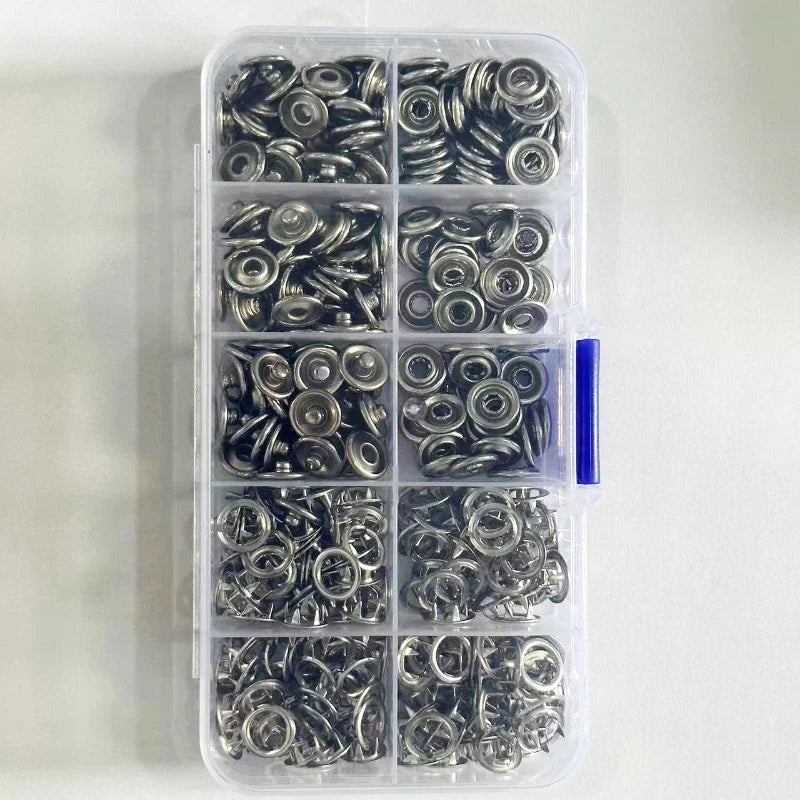A clear plastic container holds a set of silver and black five claw buckle clamps for fabric and accessories.