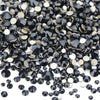 A pile of black and gold glass rhinestones for DIY crafts