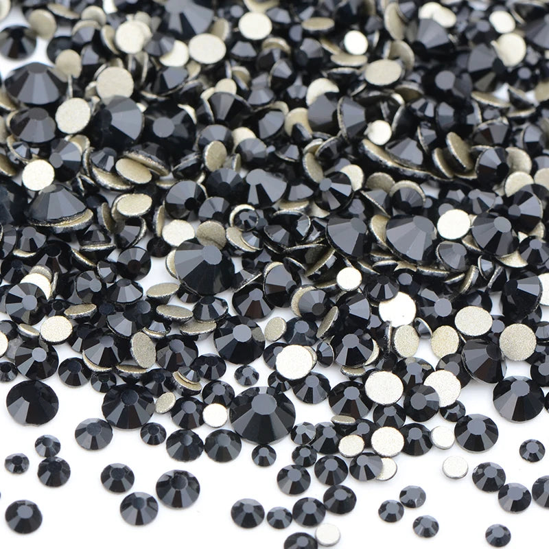 A pile of black and gold glass rhinestones for DIY crafts