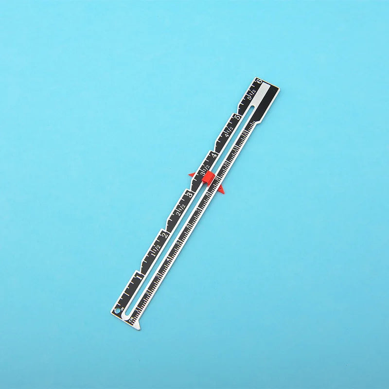A precision metal sliding sewing gauge with numbered markings is shown against a light blue background.