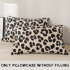 Two leopard print decorative pillow covers in beige and black spots displayed on a light surface.