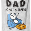 A gray blanket featuring a graphic of a sleeping figure with the text Dad is not sleeping He's just resting his eyes