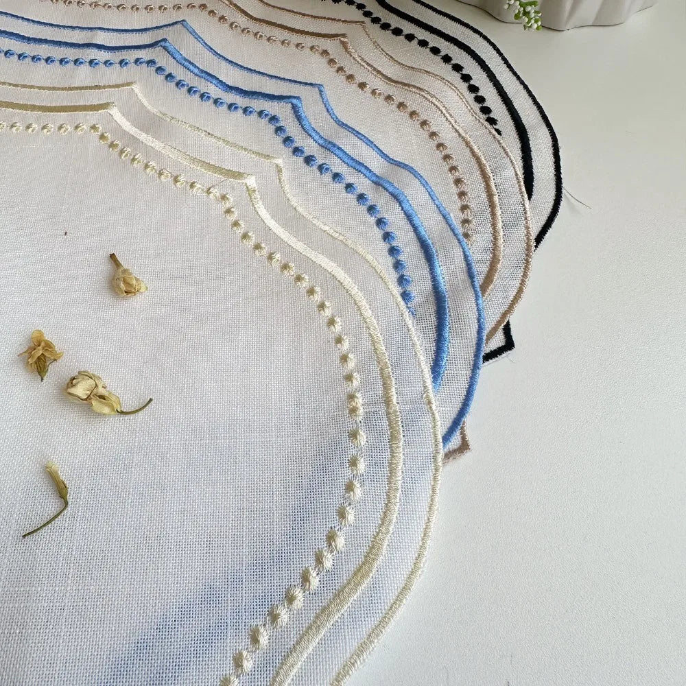 Elegant embroidered cotton linen placemat featuring blue and gold geometric patterns on white fabric