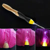 A wooden and black rechargeable LED crochet hook set with yellow accents shown against a pink yarn background.