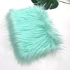 A fluffy turquoise faux fur fabric used for sewing and crafting.