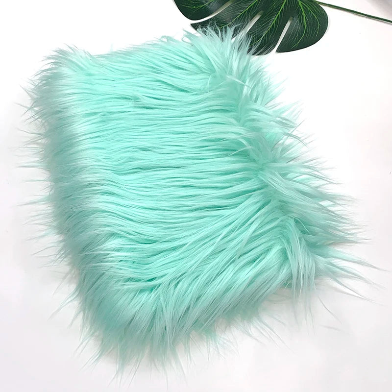 A fluffy turquoise faux fur fabric used for sewing and crafting.