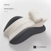 A beige ergonomic memory foam wedge pillow shown in profile with a dark grey accent.