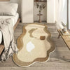 Irregular plush area rug with beige and brown abstract patterns on a wooden floor.