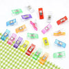Assorted colorful multipurpose sewing and craft clips in various colors like green, blue, pink, and red.