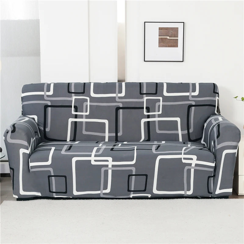 A gray and white patterned stretch floral elastic sofa cover displayed on a white floor.