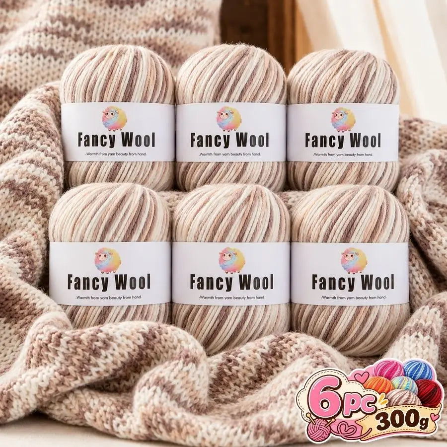 A set of three balls of fancy wool yarn in various shades of beige and brown stacked on a knitted fabric.