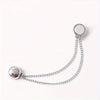 Silver adjustable hem t-shirt shortener with a chain and circular disc.