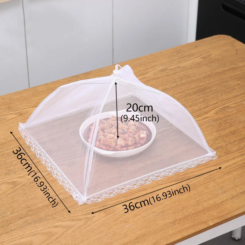 A clear mesh insect and fly protection cover with a 20cm diameter, shown on a wooden table.