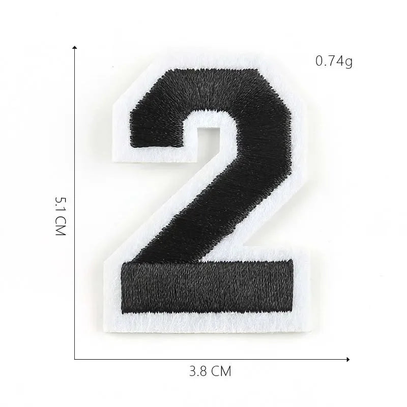 A black and white embroidered number 2 patch with dimensions of 5.1 cm by 3.8 cm and a weight of 0.74g.