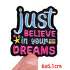 Black embroidered patch with blue text that reads Just Believe in your dreams